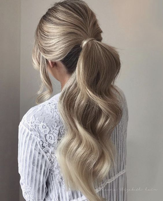 Low ponytail with clip in hair extensions.