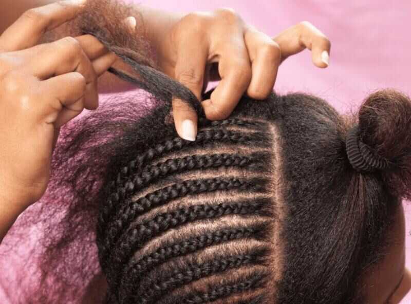 The weave portion adds volume, length, and texture to the remaining loose hair in the half braids half weave hairstyle. (Source: Bellatory)