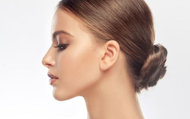 Consider a sleek low bun. (Source: Glam)