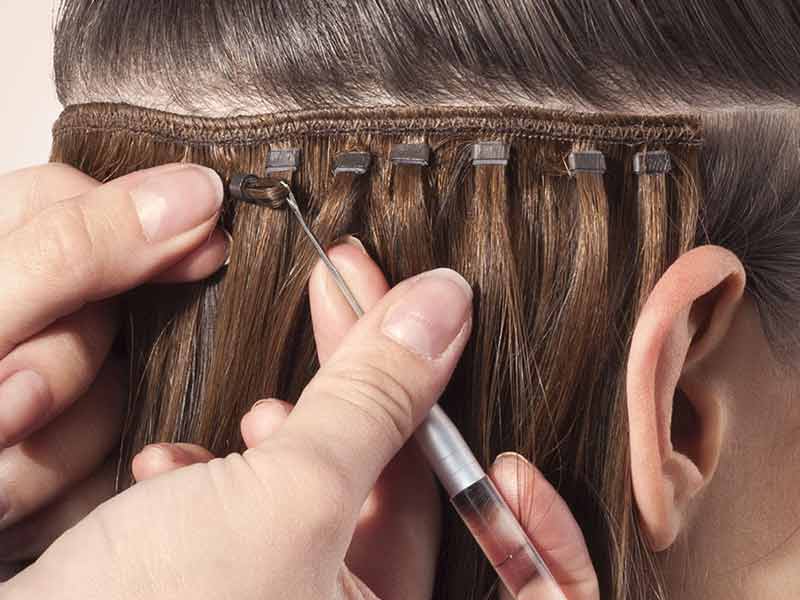 Putting in the sew-in hair extensions (Source: Vanity Hair)