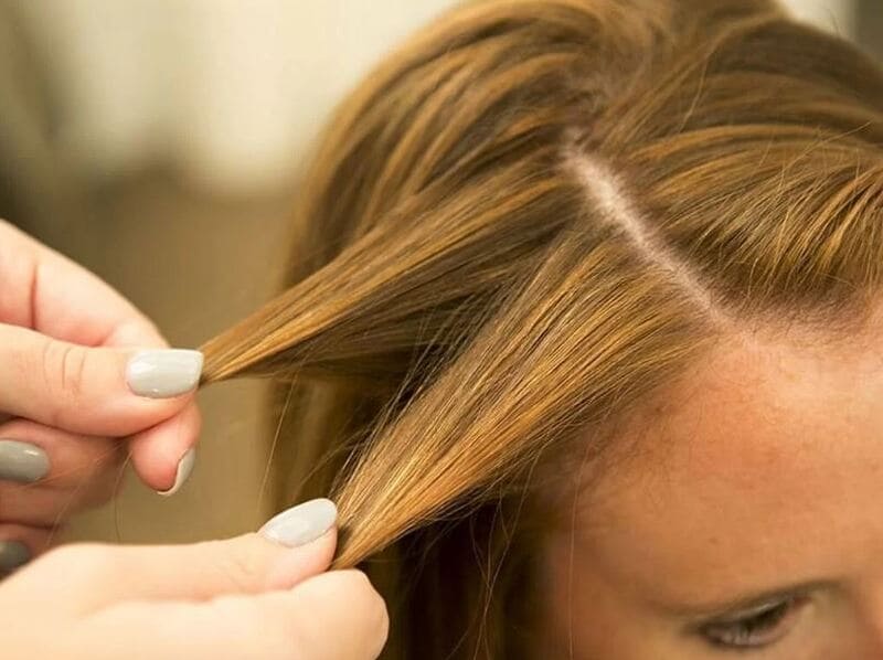 Start by separating the front section of your hair from the rest. (Source: Institute of Fashion Technology)