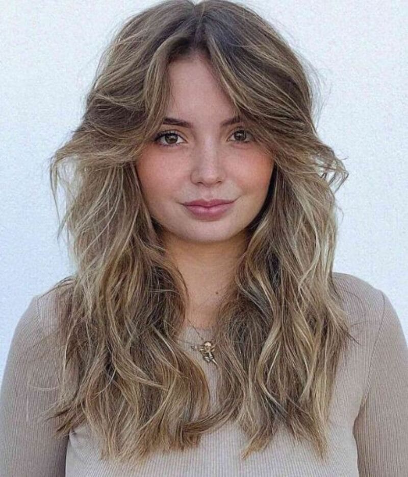 This style ensures that your curtain bangs frame your face to accentuate your unique features. (Source: Latest-Hairstyles.com)