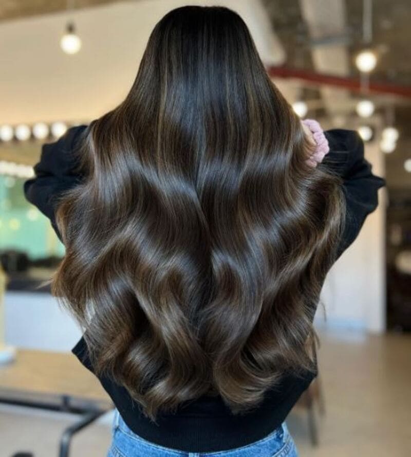 You can keep your natural brunette color while adding tasteful lowlights for added depth. (Source: Live True London)