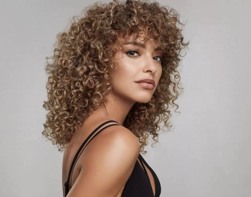 The tone-on-tone balayage technique will beautifully showcases your individual curl pattern. (Source: Pinterest)