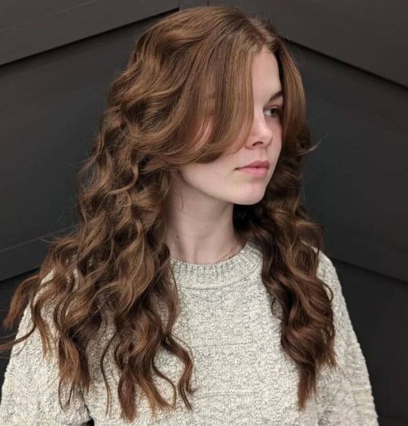 This combination of straight bangs and curly hair creates a head-turning style. (Source: Hairstyle Camp)