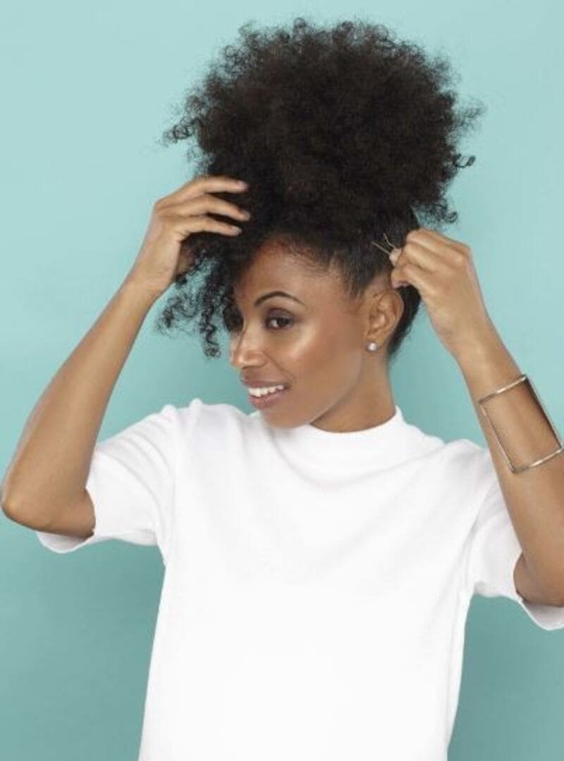 One option is to gather your natural curls into a puff. (Source: All Things Hair)