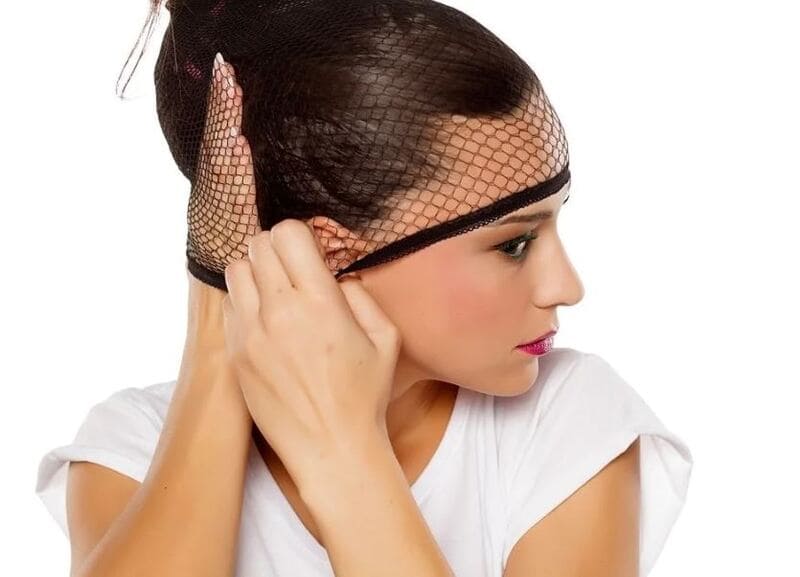 Take your time to ensure that the cap fits snugly around your bun, without causing discomfort. (Source: Eternal Wigs)