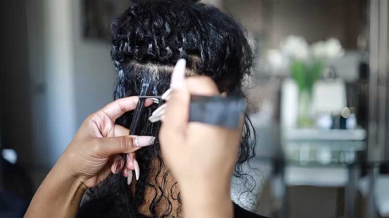 Use the rat-tail comb's pointed end to carefully loosen and remove any knots or tangles (Source: Youtube @SIMONESHARICE)