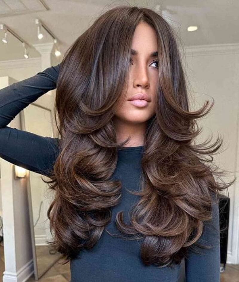 For more voluminous and flowing locks with your long thick hair, layering is the way to go. (Source: Latest-Hairstyles)