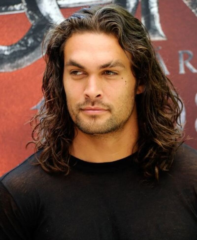 Jason Momoa possesses one of the most coveted natural long, curly male hairstyles. (Source: GQ)