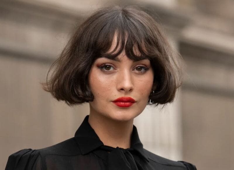 The chin-length french bob combines the charm of brunette hair shades with crafted mermaid waves. (Source: Allure)