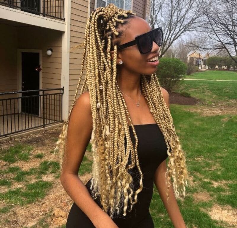 Elevate your blonde box braids to new heights of glamour by incorporating luscious curls. (Source: Pinterest)