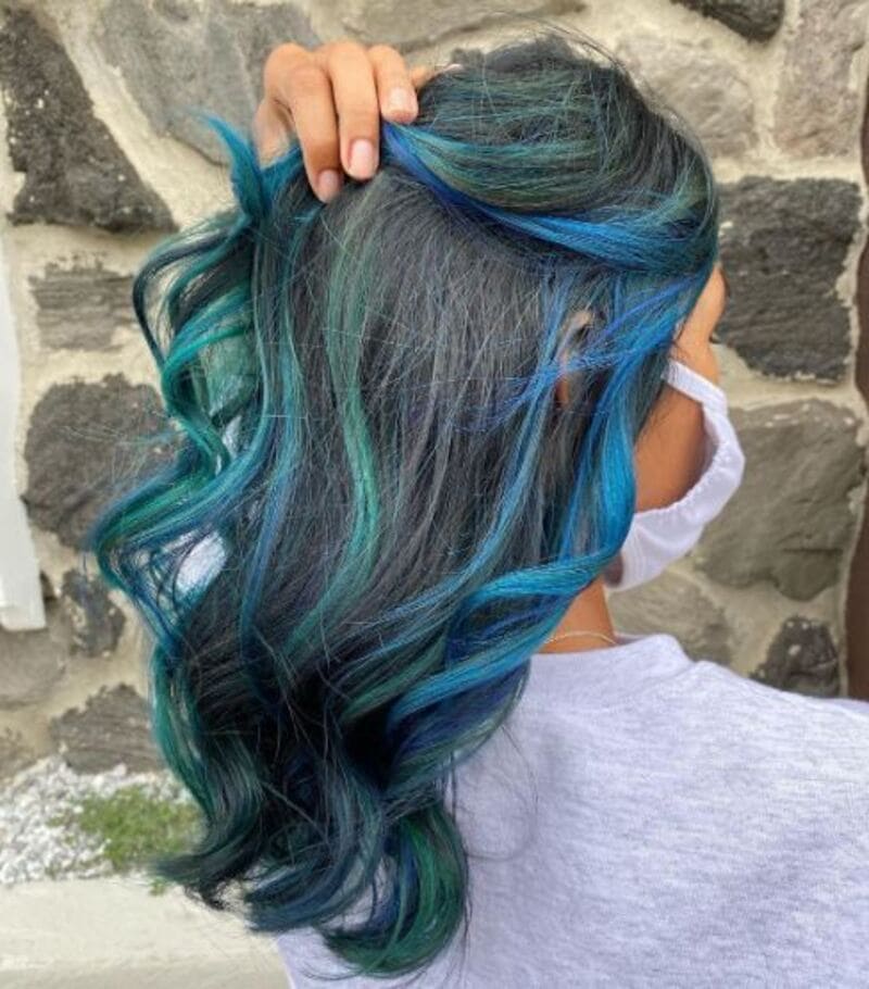 Blue hair highlights for black hair are the perfect way to add a pop of color and create a mesmerizing look. (Source: Pinterest)