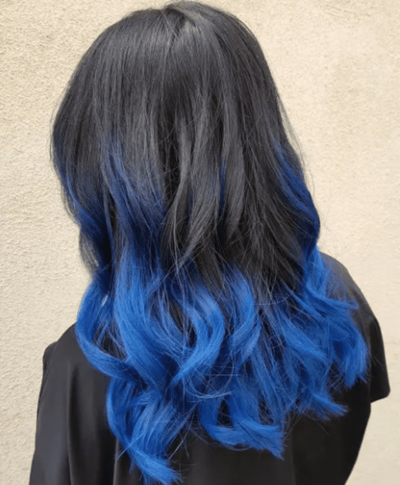 Adding blue tips to black hair involves dyeing the ends of your black hair in a vibrant shade of blue. (Source: The Right Hairstyles)