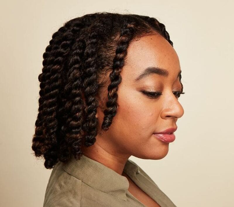 To create two-strand twists, take two sections of hair and wrapping them around each other. (Source: Byrdie)