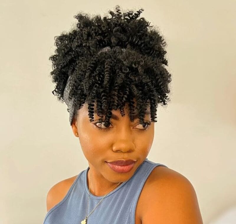 The twisted afro puff plays with texture, blending the natural afro puff with twists for a striking look. (Source: Toyotress)