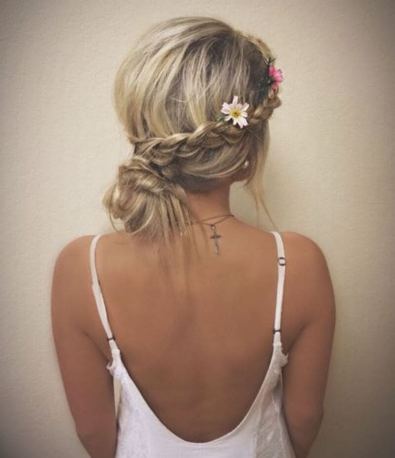 Boho vibes are what you can expect when combining a loose fishtail braid with a bun. (Source: Pinterest)