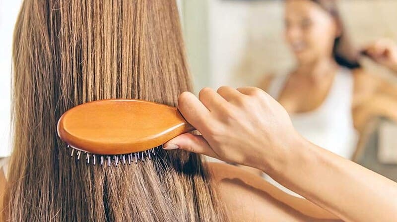 Using brushes and combs can gradually harm your hair over time. (Source: Mag the weekly)