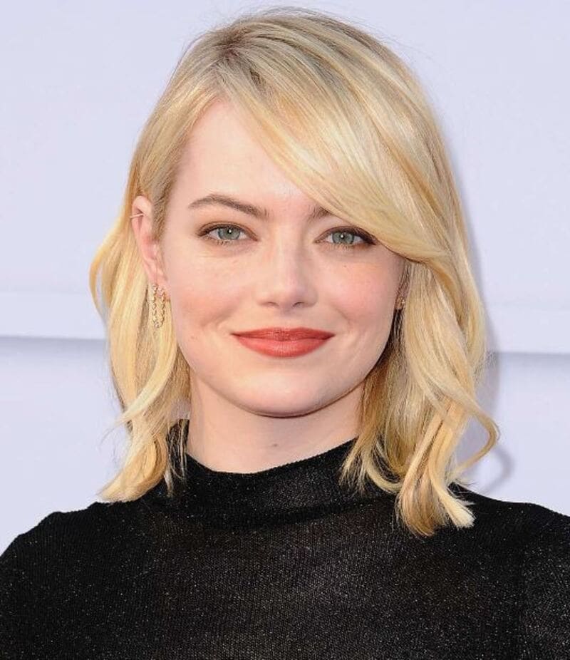 Keep this side-swept piece slightly shorter than the rest of your hair for extra face-framing volume. (Source: InStyle)