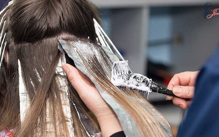 Applying the bleach on the selected section of hair