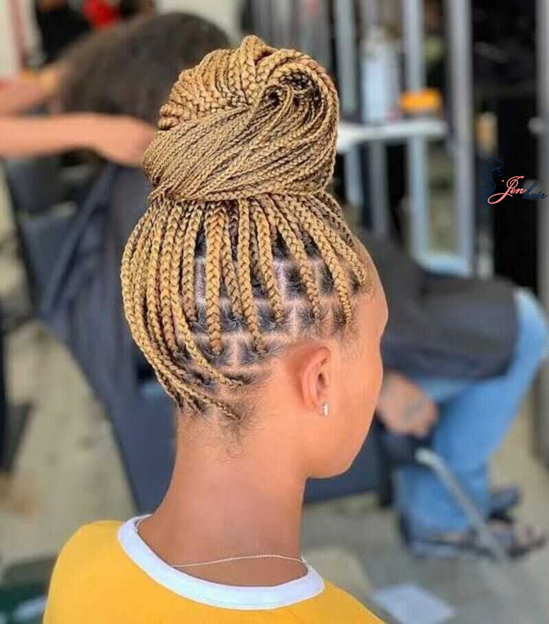 Once you have completed your medium box braids, gather all of them and secure them into an updo at the crown of your head.